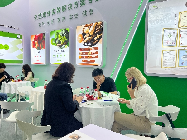 B2B meeting at the WPE natural products expo booth between supplier and manufacturer B2B meeting at the WPE natural products expo booth between supplier and manufacturer